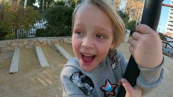 Child having exciting experience on a rope swing on the playground video