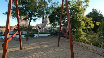 Kid enjoying exciting rope swing ride on the playground video