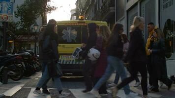 Madrid street with ambulance driving and pedestrians walking, Spain video