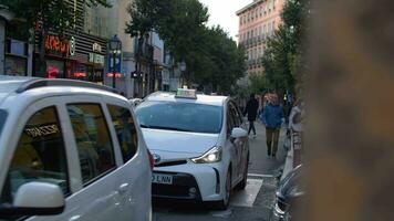 Transport and people traffic in narrow street of Madrid, Spain video