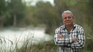 Outdoor portrait of a retired man with arms crossed video