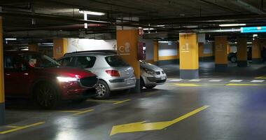 Woman leaving a car in underground car park video