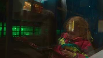 Night city view in train window with mum and child reflection video