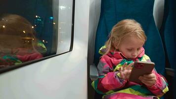 Kid using smartphone in the train video