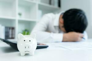 Stressed and headache man with large bills or invoices no money to pay to expenses and credit card debt. shortage, Financial problem, bankruptcy, mortgage, loan, bankrupt, poor, empty wallet photo