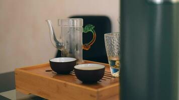 Chinese tea ceremony. a man's hand pours freshly brewed white tea into a ceramic bowl. Meditative calm mood and atmosphere video