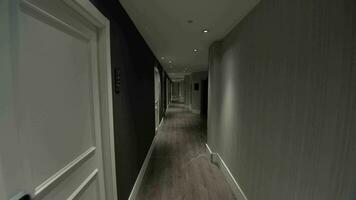 Hotel guest walking along the empty hallway video