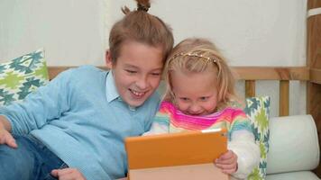 Brother and little sister play a computer game video