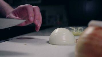 Man Slicing Onion with Chef Knife on Cutting Board video