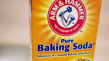 Hand placing baking soda box in front of camera video