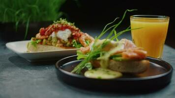 restaurant serving dishes, bruschetta with salmon, greens and juice video