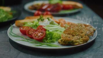 potato pancakes with salmon and salad, restaurant breakfast on a plate video