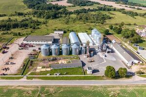 aerial panoramic view on agro-industrial complex with silos and grain drying line for drying cleaning and storage of cereal crops photo
