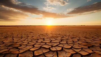 seco agrietado tierra a atardecer, global calentamiento, clima cambio concepto foto