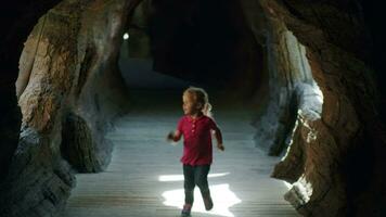 Child running along the imitated cave video