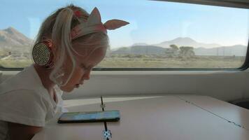 Kid watching mobile video during the train ride