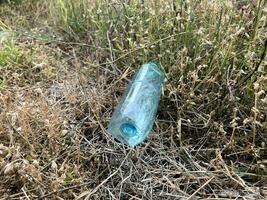 a bottle of water in the forest. environmental problem. photo