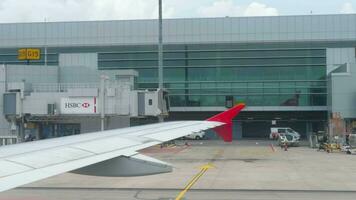 CHANGI, SINGAPORE NOVEMBER 22, 2018  - Terminal 4 in Changi Airport view from taxiing airplane AirAsia, airplanes parked near terminal. video