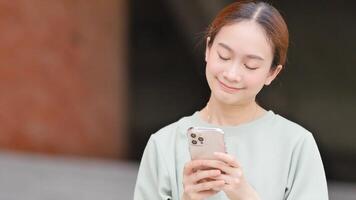 femme envoyer des SMS sur téléphone en plein air video