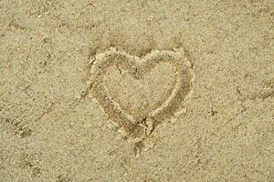 heart drawn on the sand photo