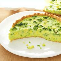 Broccoli quiche on a white plate. Shallow dof. Generative AI photo