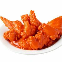 Fried chicken wings in tomato sauce on white plate isolated on white background. Generative AI photo