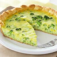 Broccoli quiche on a white plate. Shallow dof. Generative AI photo