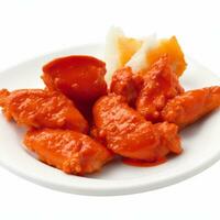 Fried chicken wings in tomato sauce on white plate isolated on white background. Generative AI photo