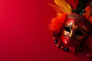 Beautiful carnival mask with feathers on red background with copyspace photo