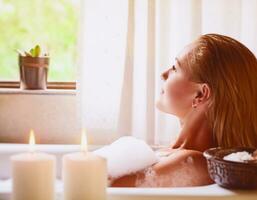 Woman relaxing in bathtub photo