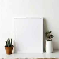 Mockup of an empty and blank vertical frame. White frame mock up with plant in pot on wooden table and white wall. AI generated. photo