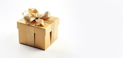 Gift box with a gold bow on a white background with space for text. Stylish decorative box. photo