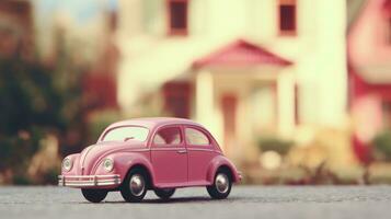 Pink toy classic car on the background of a blurred dollhouse. Toy world photo