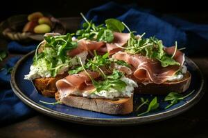 Sandwiches with cream cheese prosciutto cucumber and arugula on plate photo