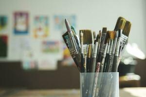 Close up of painting brushes in studio of artist. photo