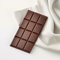 Smooth Glossy Chocolate Bar Resting on White Linen Backdrop with Copyspace Right AI Generative photo