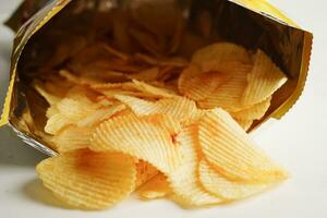 Potato chips in open bag, delicious BBQ seasoning spicy for crips, thin slice deep fried snack fast food. photo