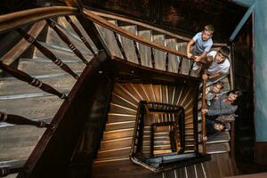 Mother with four kids standing in old vintage stairs, above view. photo