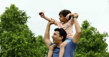 Video of father and son dreaming of flying while sitting on his father shoulders