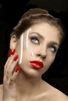 Face cream flows down the girl's skin and red lips. Skin care concept. photo