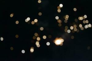 On a black background bokeh from explosions of colorful fireworks. photo