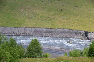 Mountain river against the background of cobblestones and stones. photo