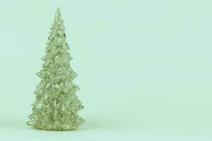 Christmas composition. Emerald vintage Christmas tree on a green background. Happy Holidays. Minimal new year concept. photo