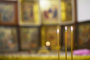 Church candles on the background of blurry icons. Church Projects Background photo