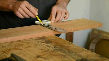 Craftsman or carpenter mark out in a table wood video