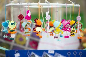 The handicraft fair sells colorful knitted toys and small dolls. photo