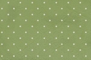 Green paper background with white polka dots. photo