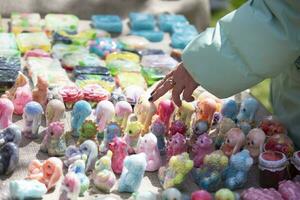 Sale at the fair of handmade soap. The buyer's hand points to the product he likes. photo