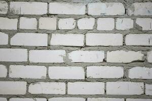 Texture of an old brick wall with gray plaster. photo