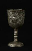 Antique silver royal goblet with grape engraving. photo